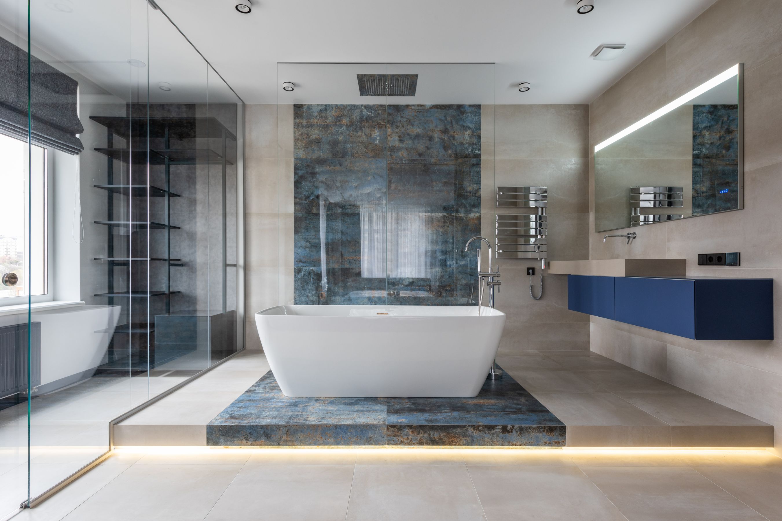 Finished bathroom with a freestanding tub and stone feature wall