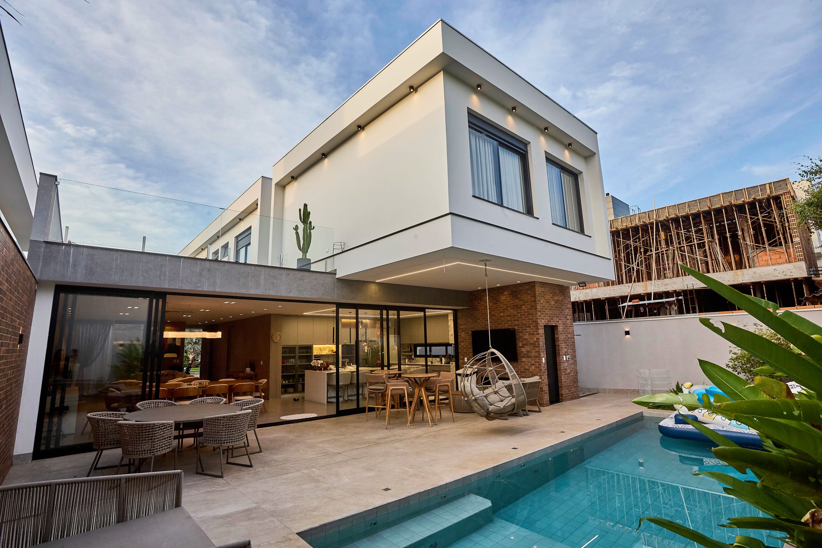 Finished modern house with a pool and an outdoor dining area