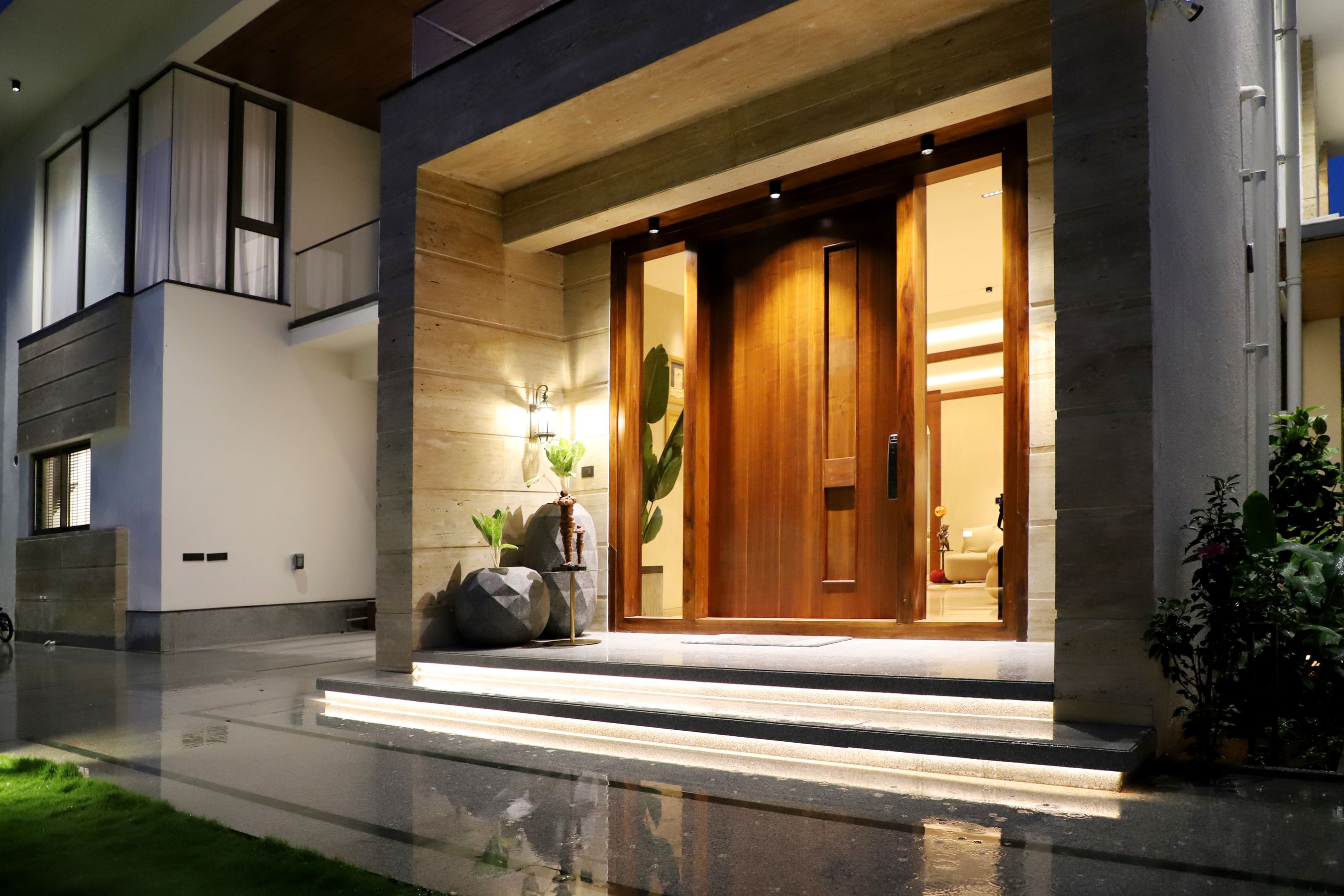Finished front entrance with lit steps at night