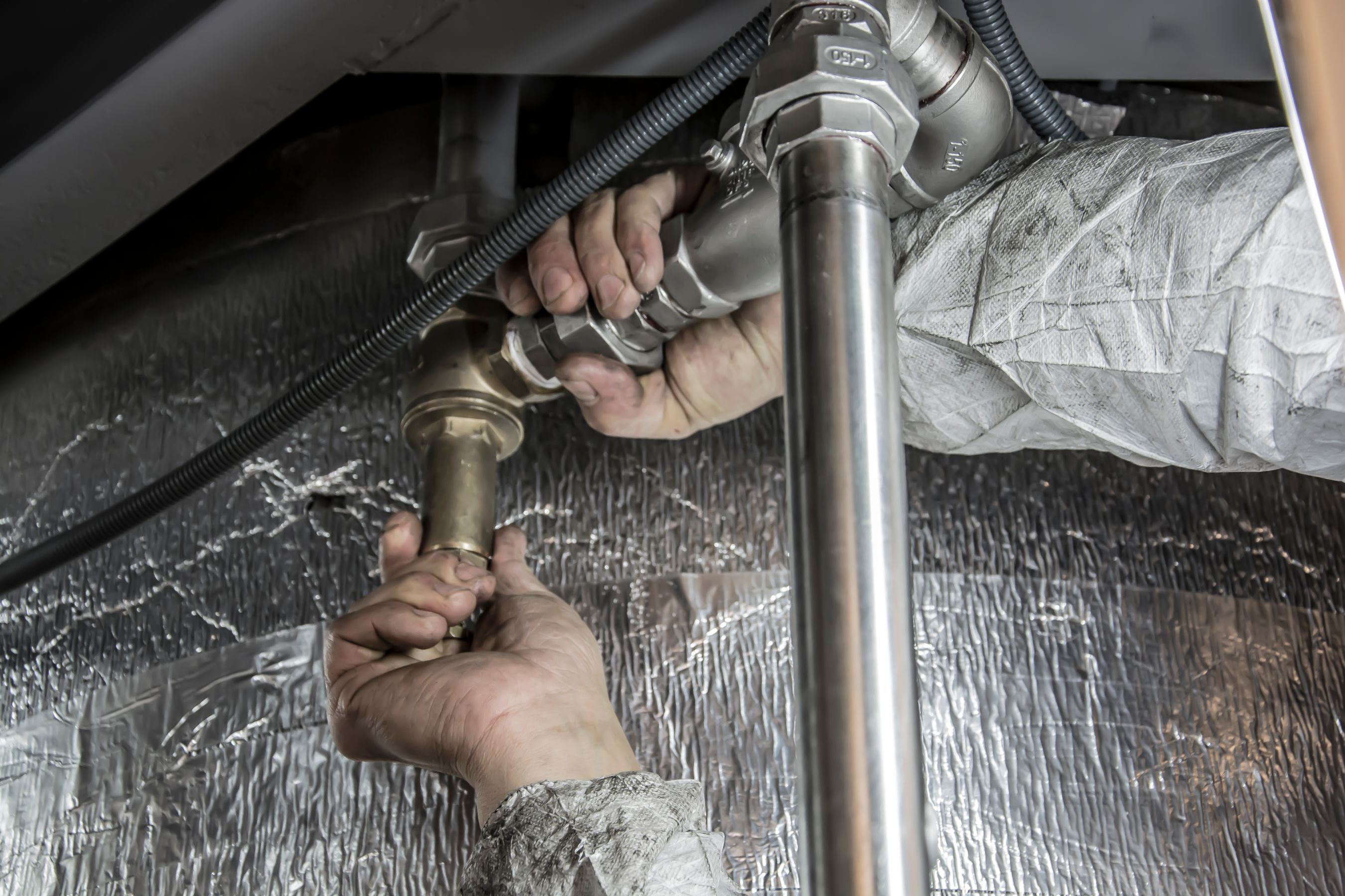 Plumber fitting pipes during the mechanical rough-in