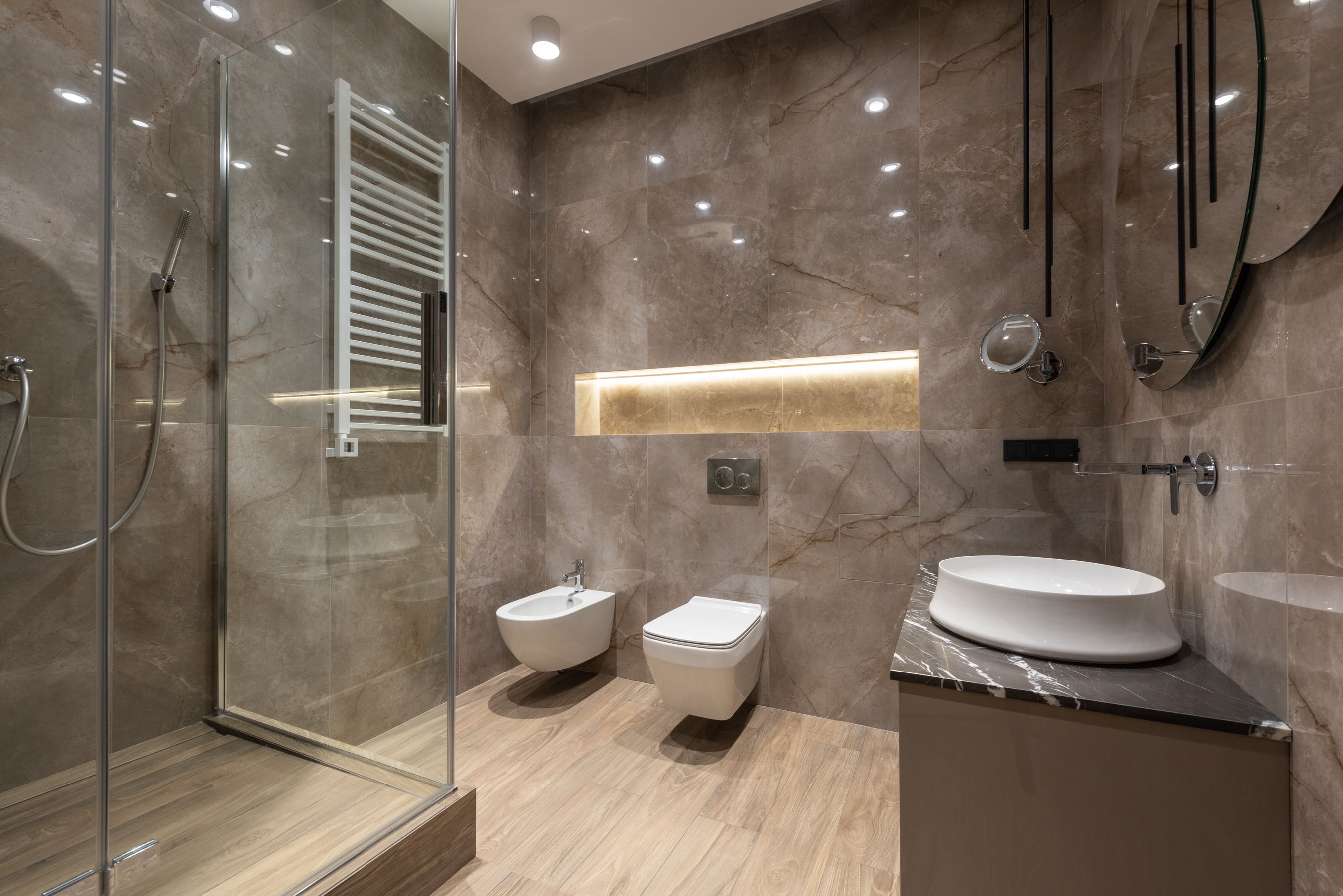 Finished spa bathroom with a glass shower and stone walls